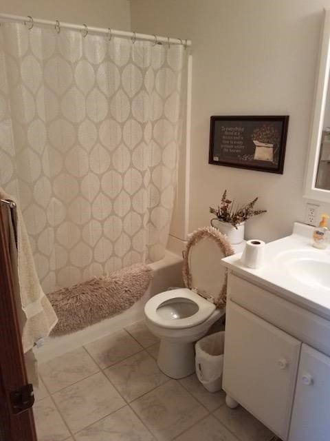 full bathroom featuring tile patterned floors, shower / tub combo with curtain, vanity, and toilet