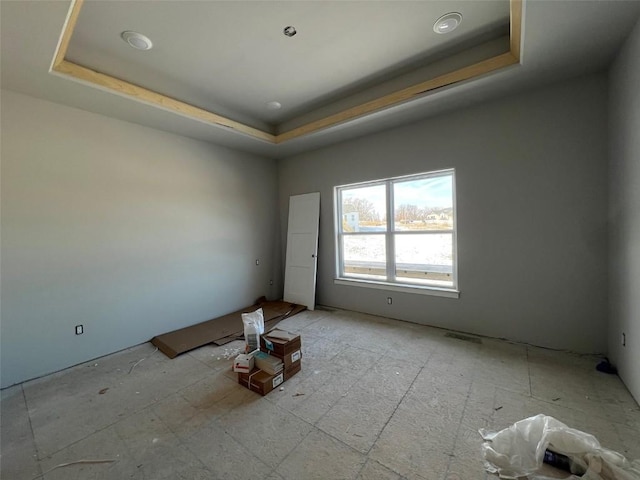 spare room featuring a tray ceiling