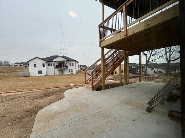 view of yard featuring stairs, a patio area, and a wooden deck