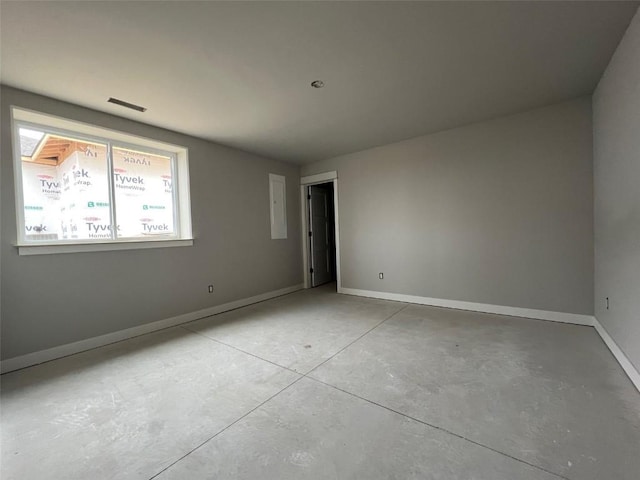 unfurnished room with baseboards and concrete flooring