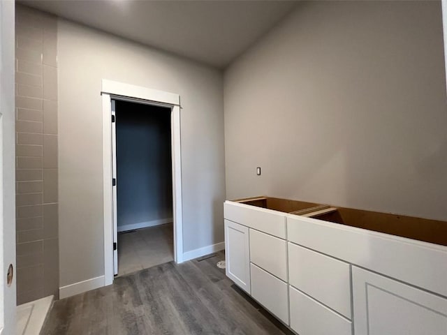 bathroom with wood finished floors and baseboards