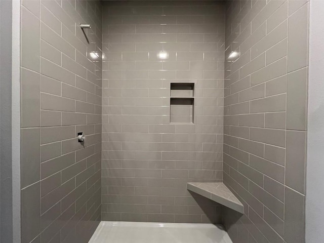 bathroom with a tile shower