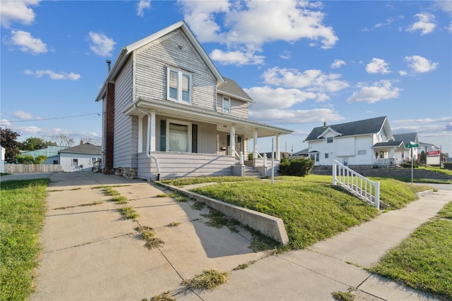 view of front of home with a front lawn and covered porch