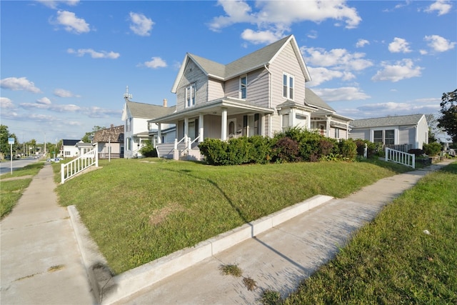 view of front of house featuring covered porch and a front lawn