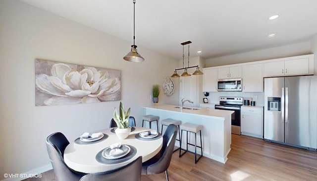 dining room featuring light wood-style floors and recessed lighting