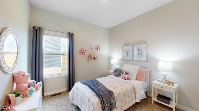 bedroom with carpet floors, baseboards, multiple windows, and visible vents