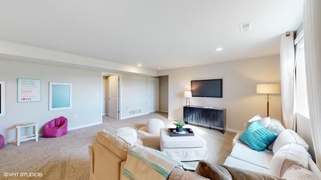 living room with baseboards, visible vents, recessed lighting, and light colored carpet