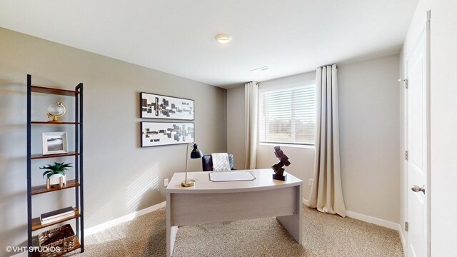 office with baseboards and light colored carpet