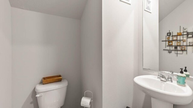 bathroom featuring sink and toilet