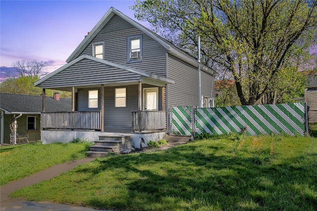 view of front facade with cooling unit, a yard, and covered porch