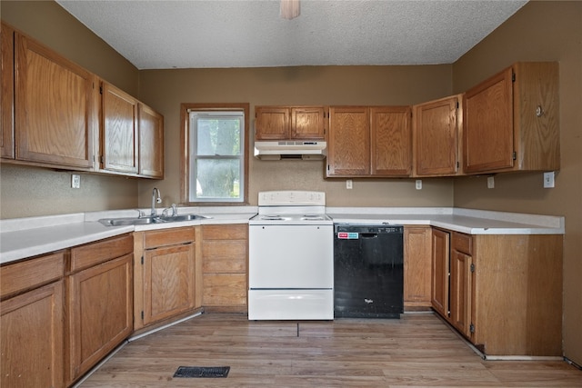 kitchen with black dishwasher, light hardwood / wood-style flooring, a textured ceiling, and white range oven