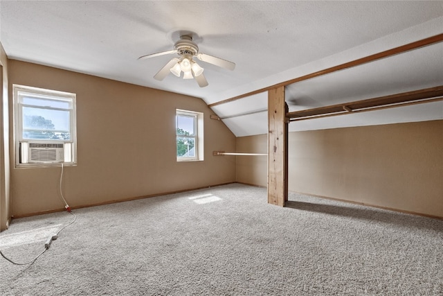 interior space with a textured ceiling, cooling unit, vaulted ceiling, and ceiling fan