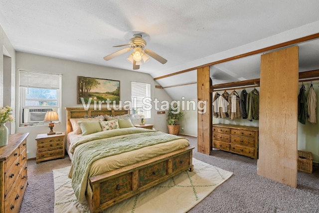 carpeted bedroom featuring a textured ceiling, lofted ceiling, and ceiling fan