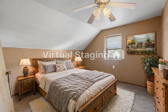 carpeted bedroom with a textured ceiling, lofted ceiling, and ceiling fan