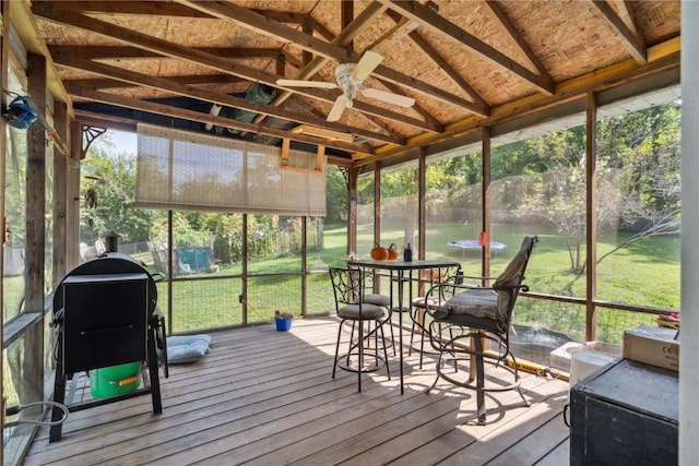 sunroom with vaulted ceiling with beams and ceiling fan