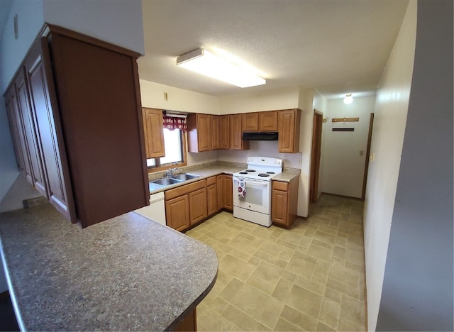 kitchen with white appliances, a textured ceiling, and sink