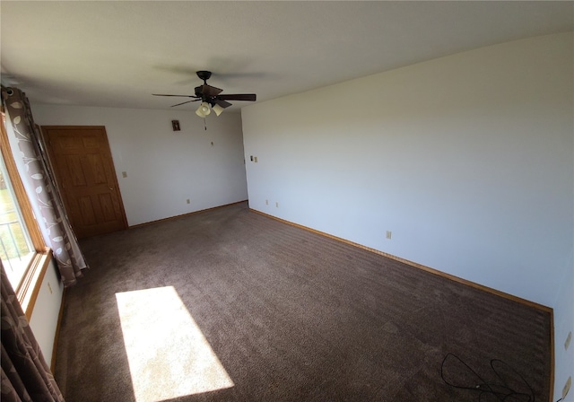 unfurnished bedroom with dark colored carpet and ceiling fan