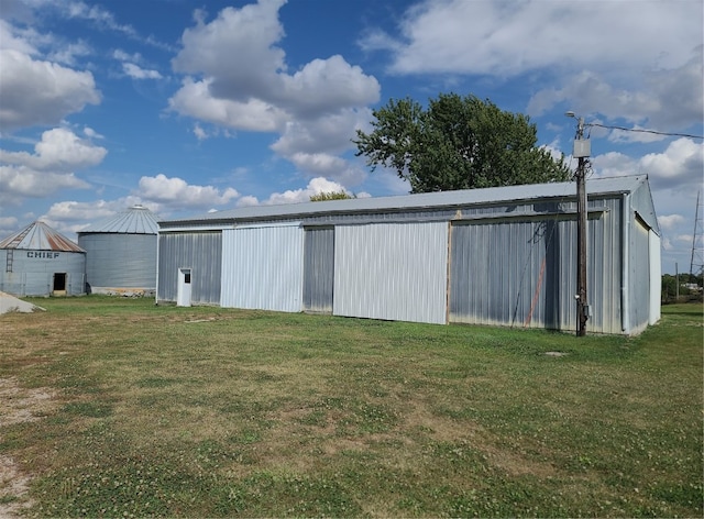 view of outbuilding featuring a yard