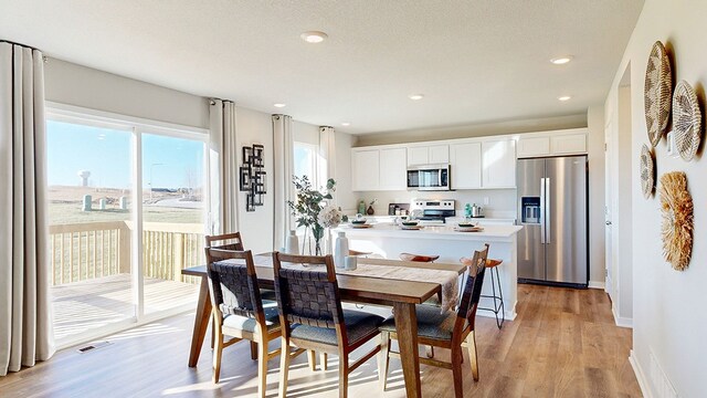 dining room with light hardwood / wood-style flooring