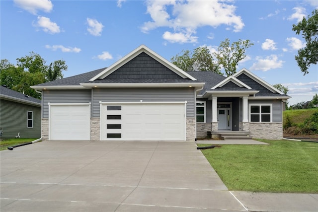 craftsman inspired home featuring a front yard and a garage