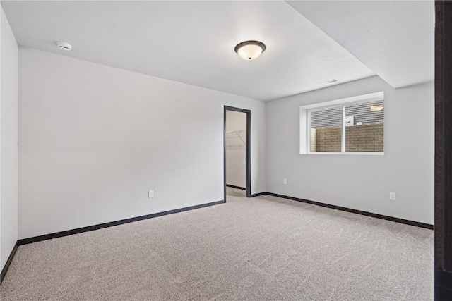 spare room featuring light colored carpet