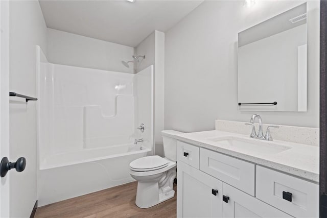 full bathroom with vanity, shower / bath combination, hardwood / wood-style flooring, and toilet