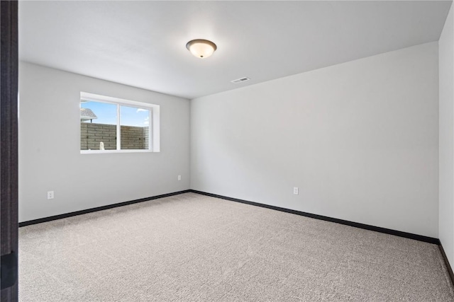 empty room featuring light carpet