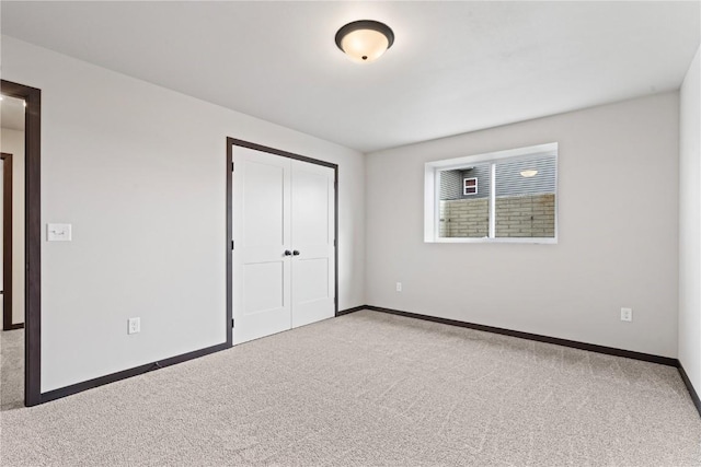 unfurnished bedroom featuring a closet and carpet floors