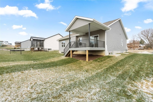 back of house with a lawn and a wooden deck