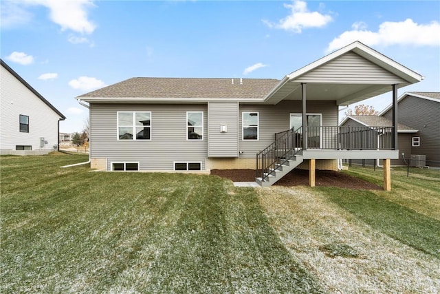 back of house with a yard and central AC unit