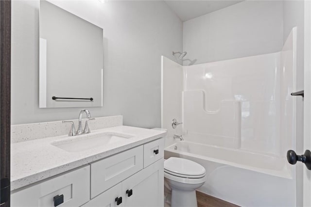 full bathroom with vanity,  shower combination, toilet, and wood-type flooring