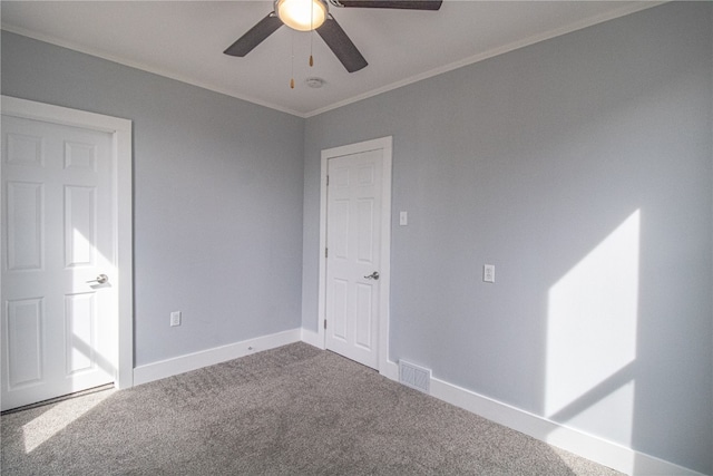 carpeted empty room with crown molding and ceiling fan