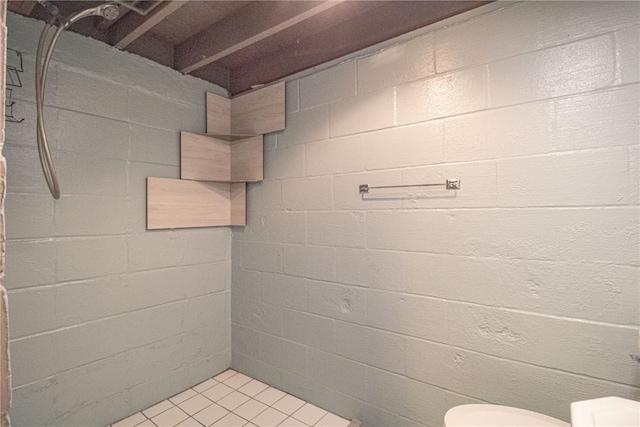 bathroom featuring a shower, toilet, and tile patterned floors