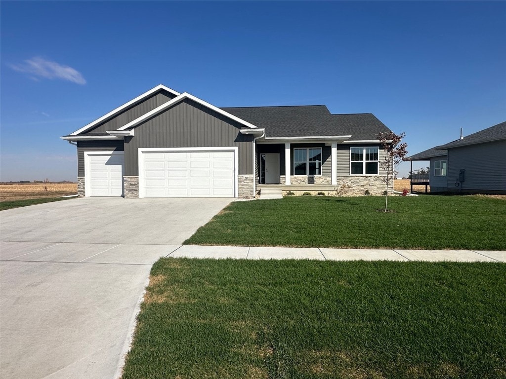 craftsman-style house featuring a front yard and a garage