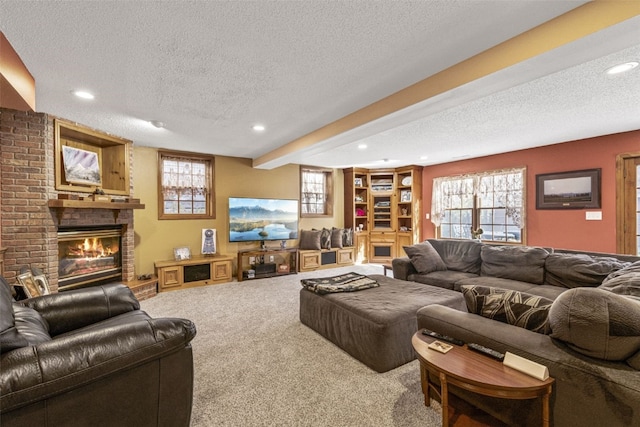 living room featuring carpet flooring, plenty of natural light, and a textured ceiling