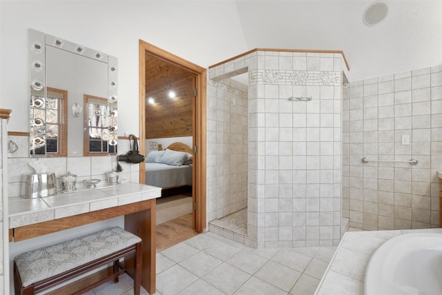 bathroom featuring sink, vaulted ceiling, hardwood / wood-style flooring, tile walls, and independent shower and bath