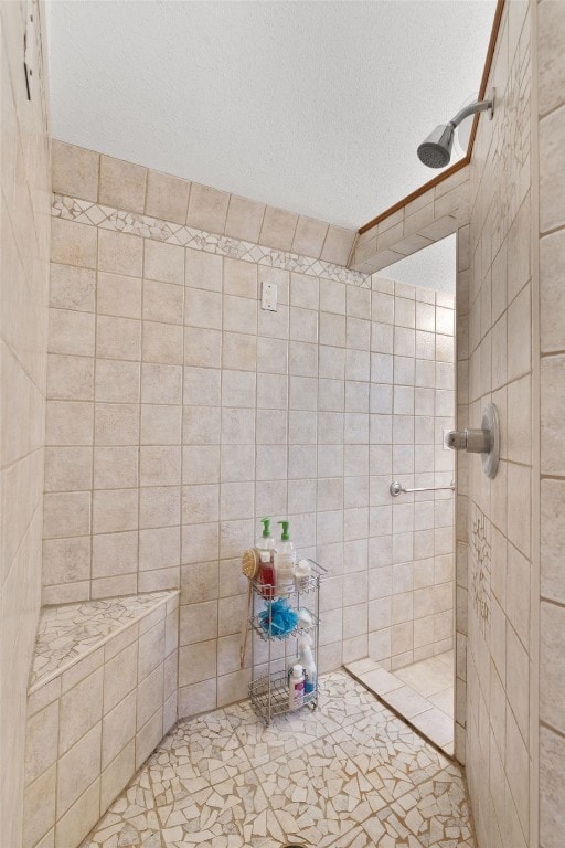 bathroom featuring tiled shower and a textured ceiling