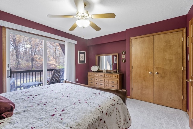 carpeted bedroom featuring access to outside, ceiling fan, a closet, and a textured ceiling