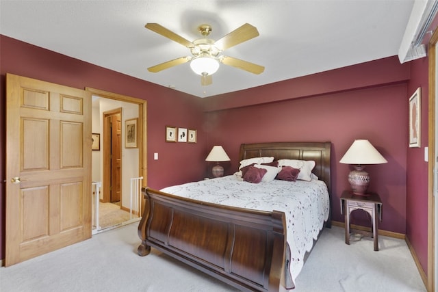 bedroom with ceiling fan and light colored carpet