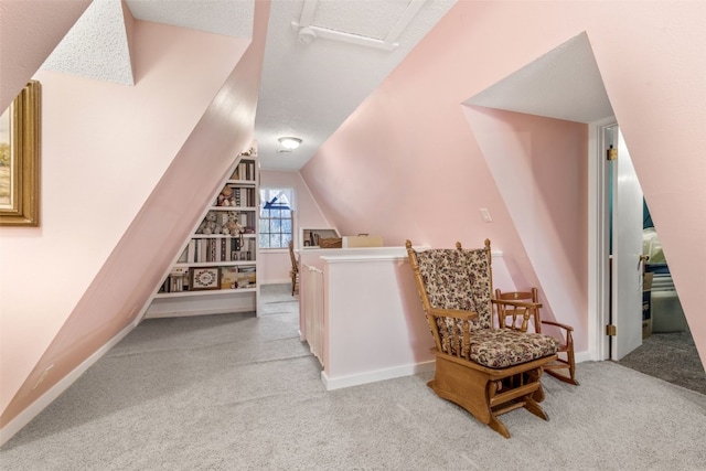 bonus room featuring lofted ceiling, light carpet, and a textured ceiling