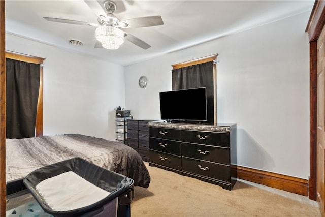 bedroom with ceiling fan and light colored carpet