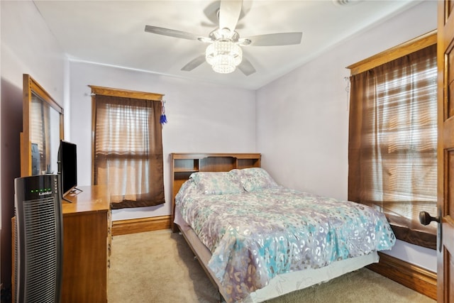 bedroom with light carpet and ceiling fan