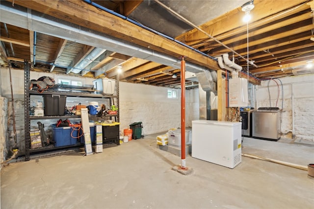 basement featuring refrigerator and washer / clothes dryer