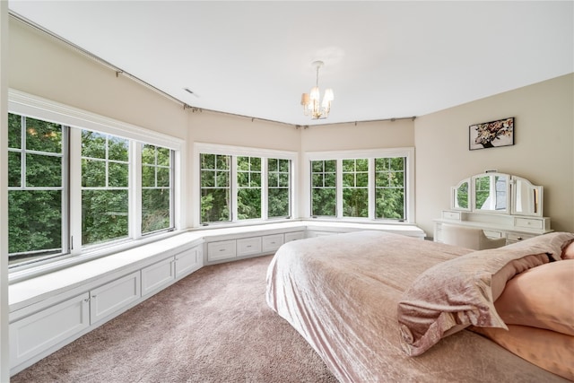 carpeted bedroom with a notable chandelier