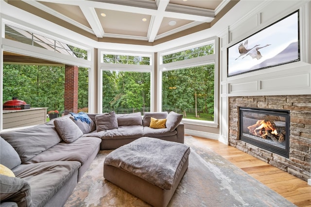 living room featuring coffered ceiling, a fireplace, beam ceiling, hardwood / wood-style flooring, and ornamental molding