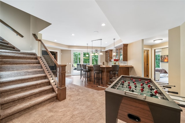 playroom with dark carpet and bar area