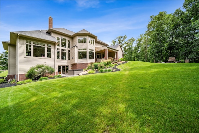 back of house featuring a yard