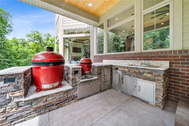 view of patio / terrace with area for grilling, an outdoor kitchen, and sink