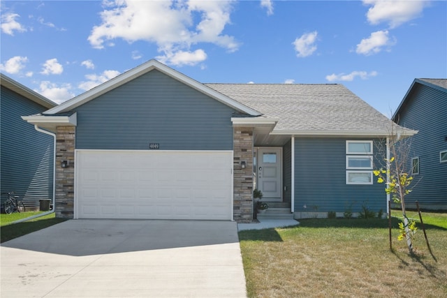 view of front of property with a front lawn and a garage