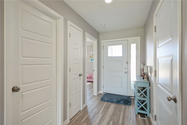 foyer entrance with light hardwood / wood-style flooring